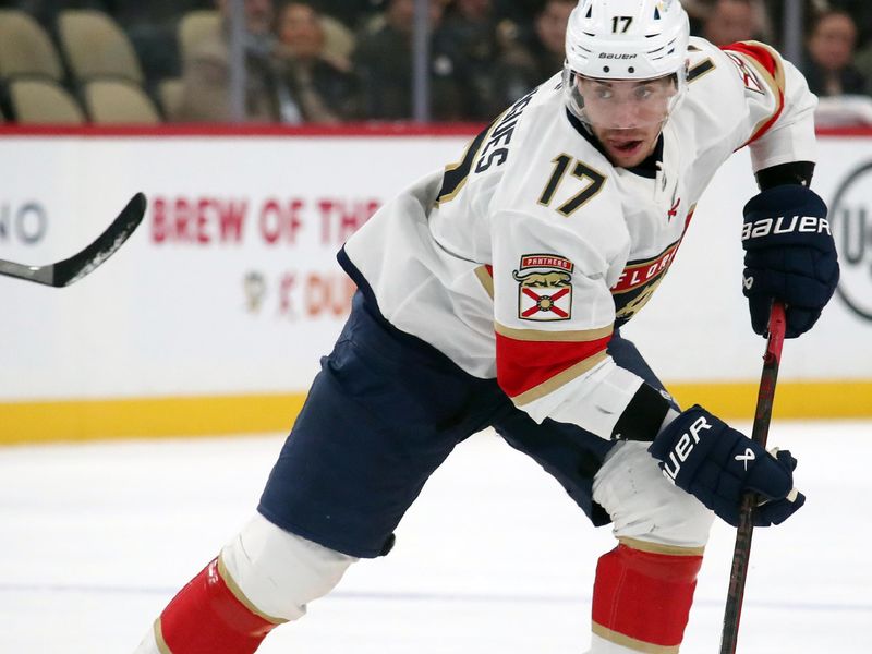 Dec 3, 2024; Pittsburgh, Pennsylvania, USA;  Florida Panthers center Evan Rodrigues (17) skates up ice with the puck against the Pittsburgh Penguins during the third period at PPG Paints Arena. Mandatory Credit: Charles LeClaire-Imagn Images