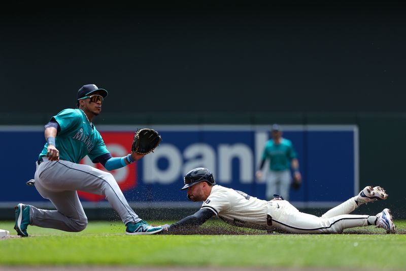 May 9, 2024; Minneapolis, Minnesota, USA; Minnesota Twins Edouard Julien (47) steals second base as Seattle Mariners second baseman Jorge Polanco (7) fields the ball during the first inning at Target Field. Mandatory Credit: Matt Krohn-USA TODAY Sports