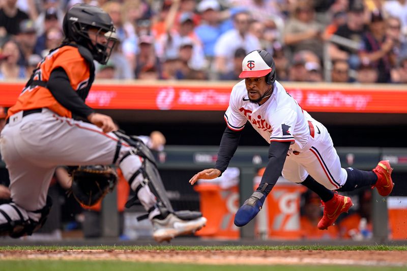 Jul 8, 2023; Minneapolis, Minnesota, USA; Minnesota Twins designated hitter Byron Buxton (25) dives for the plate and scores a run against the Baltimore Orioles during the sixth inning at Target Field. Mandatory Credit: Nick Wosika-USA TODAY Sports
