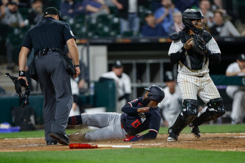 Apr 30, 2024; Chicago, Illinois, USA; Minnesota Twins outfielder Manuel Margot (13) scores against the Chicago White Sox during the eight inning at Guaranteed Rate Field. Mandatory Credit: Kamil Krzaczynski-USA TODAY Sports