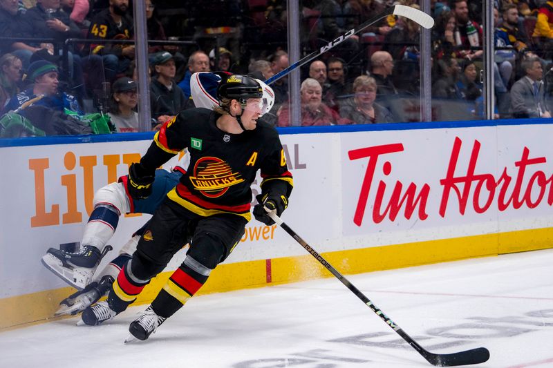 Dec 6, 2024; Vancouver, British Columbia, CAN; Vancouver Canucks forward Brock Boeser (6) checks Columbus Blue Jackets defenseman Jake Christiansen (2) during the second period at Rogers Arena. Mandatory Credit: Bob Frid-Imagn Images