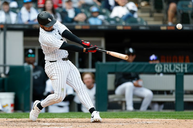 May 24, 2025; Chicago, Illinois, USA; Chicago White Sox second baseman Lenyn Sosa (50) hits a three-run double against the Texas Rangers during the sixth inning at Rate Field. Mandatory Credit: Kamil Krzaczynski-Imagn Images