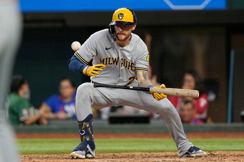 Aug 20, 2023; Arlington, Texas, USA; Milwaukee Brewers second baseman Brice Turang (2) successfully bunts for a single against the Texas Rangers during the eighth inning at Globe Life Field. Mandatory Credit: Jim Cowsert-USA TODAY Sports