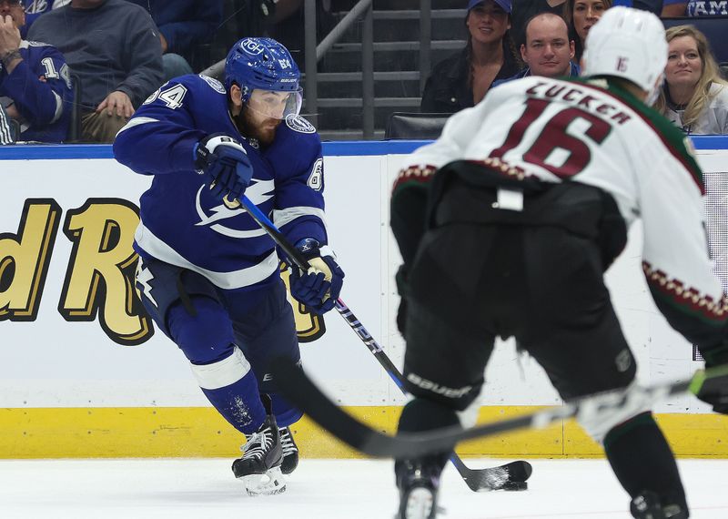 Jan 25, 2024; Tampa, Florida, USA; Tampa Bay Lightning center Tyler Motte (64) passes the puck against the Arizona Coyotes during the third period at Amalie Arena. Mandatory Credit: Kim Klement Neitzel-USA TODAY Sports