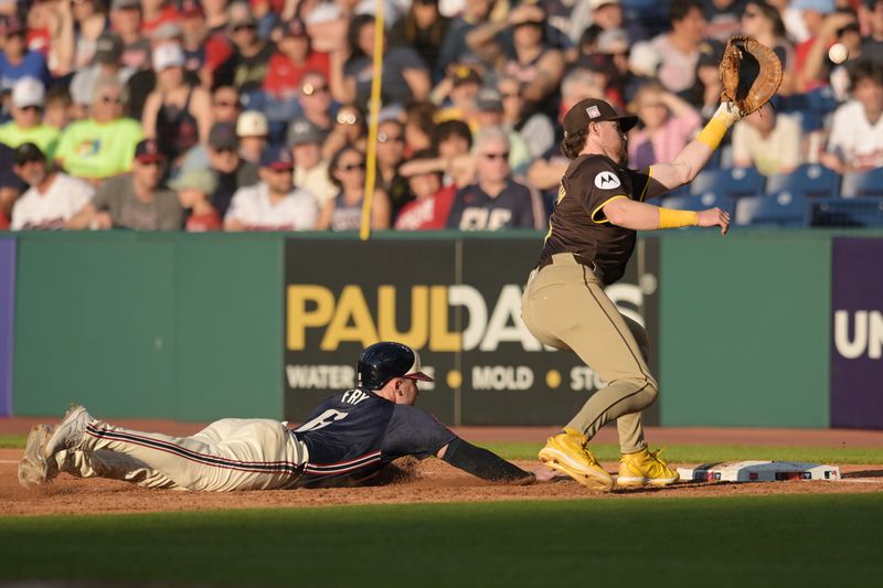 Jul 19, 2024; Cleveland, Ohio, USA; Cleveland Guardians designated hitter David Fry (6) dives back to first as San Diego Padres first baseman Jake Cronenworth (9) waits for the throw from catcher Kyle Higashioka (20) during the second inning at Progressive Field. Mandatory Credit: Ken Blaze-USA TODAY Sports