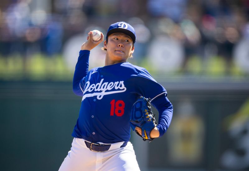 Mar 13, 2024; Phoenix, Arizona, USA; Los Angeles Dodgers pitcher Yoshinobu Yamamoto against the Seattle Mariners during a spring training game at Camelback Ranch-Glendale. Mandatory Credit: Mark J. Rebilas-USA TODAY Sports
