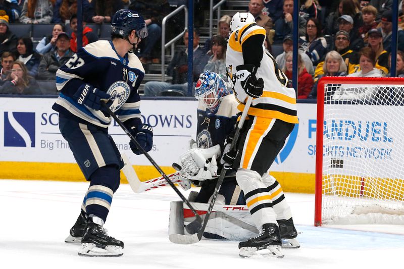 Nov 15, 2024; Columbus, Ohio, USA; Columbus Blue Jackets goalie Elvis Merzlikins (90) makes a save as Pittsburgh Penguins center Rickard Rakell (67) looks for a rebound during the second period at Nationwide Arena. Mandatory Credit: Russell LaBounty-Imagn Images