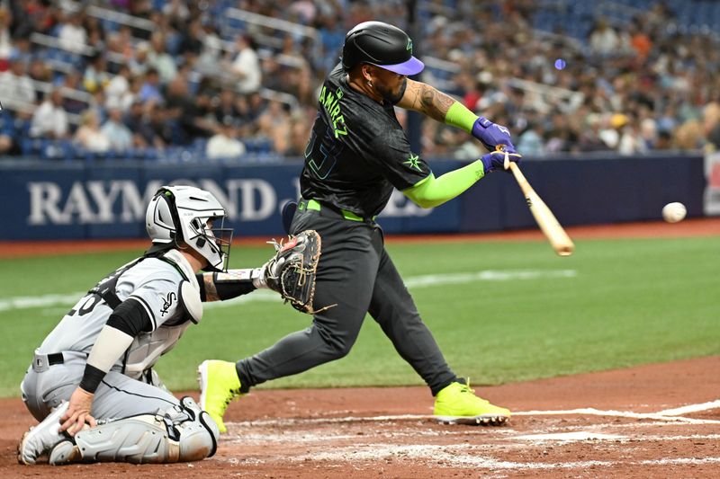 May 7, 2024; St. Petersburg, Florida, USA; Tampa Bay Rays designated hitter Harold Ramirez (43) hits an RBI single in the second inning against the Chicago White Sox at Tropicana Field. Mandatory Credit: Jonathan Dyer-USA TODAY Sports
