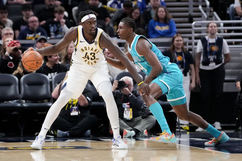 INDIANAPOLIS, INDIANA - OCTOBER 17: Pascal Siakam #43 of the Indiana Pacers dribbles the ball while being guarded by Moussa Diabate #14 of the Charlotte Hornets in the second quarter during a preseason game at Gainbridge Fieldhouse on October 17, 2024 in Indianapolis, Indiana. NOTE TO USER: User expressly acknowledges and agrees that, by downloading and or using this photograph, User is consenting to the terms and conditions of the Getty Images License Agreement. (Photo by Dylan Buell/Getty Images)