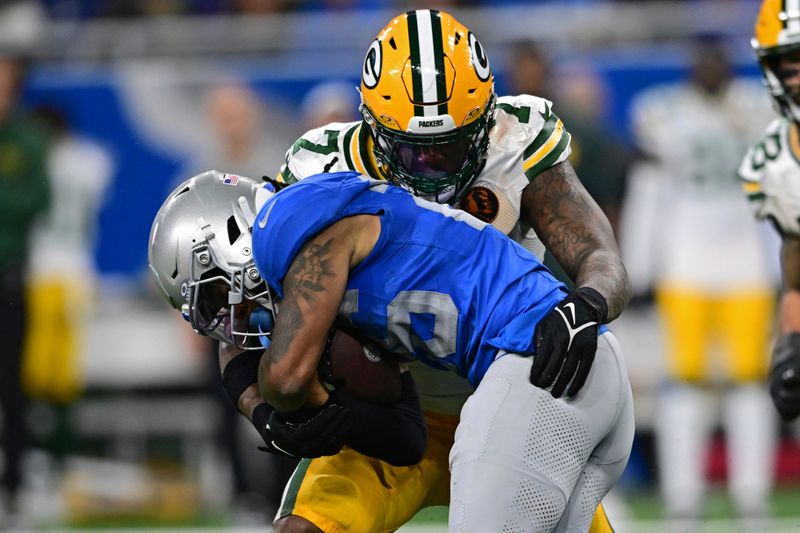 Detroit Lions running back Jahmyr Gibbs is tackle day Green Bay Packers linebacker Quay Walker during the second half of an NFL football game, Thursday, Nov. 23, 2023, in Detroit. The Packers won 29-22. (AP Photo/David Dermer)