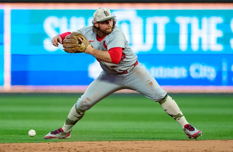 May 16, 2025; Kansas City, Missouri, USA; St. Louis Cardinals second baseman Brendan Donovan (33) drops the ball while attempting to throw to first base during the fifth inning against the Kansas City Royals at Kauffman Stadium. Mandatory Credit: Jay Biggerstaff-Imagn Images