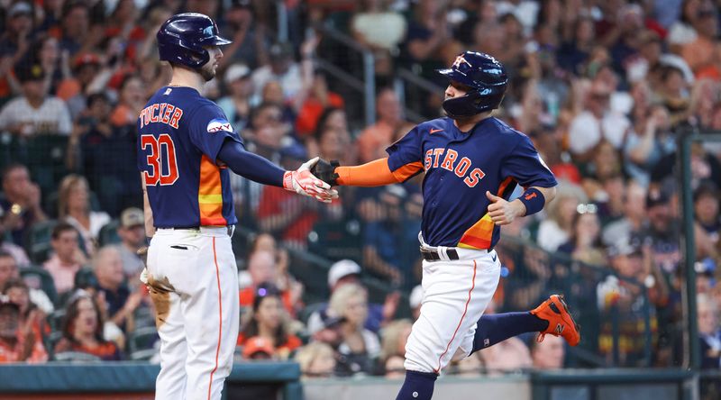 Sep 10, 2023; Houston, Texas, USA; Houston Astros second baseman Jose Altuve (27) celebrates with right fielder Kyle Tucker (30) after scoring during the sixth inning against the San Diego Padres at Minute Maid Park. Mandatory Credit: Troy Taormina-USA TODAY Sports