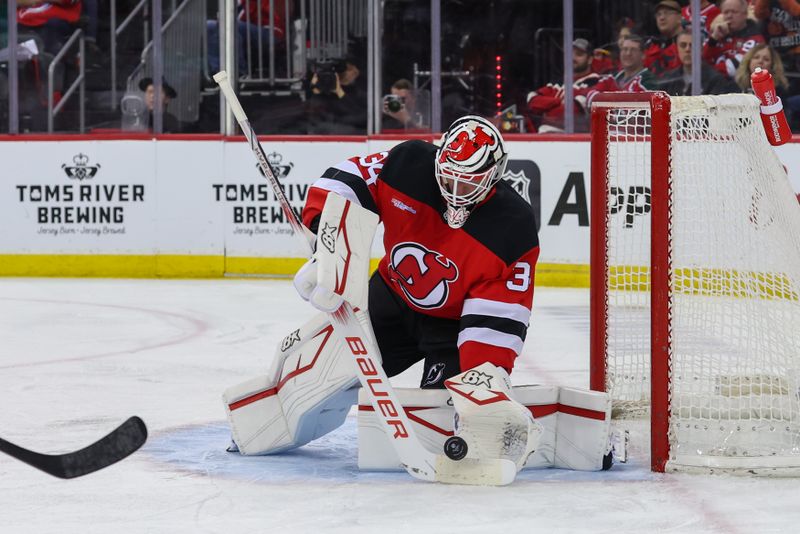 Jan 18, 2025; Newark, New Jersey, USA; New Jersey Devils goaltender Jake Allen (34) makes a save against the Philadelphia Flyers during the third period at Prudential Center. Mandatory Credit: Ed Mulholland-Imagn Images