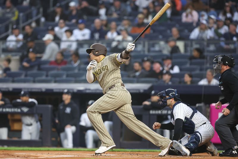 May 6, 2025; Bronx, New York, USA;  San Diego Padres third baseman Manny Machado (13) hits a single in the first inning against the New York Yankees at Yankee Stadium. Mandatory Credit: Wendell Cruz-Imagn Images