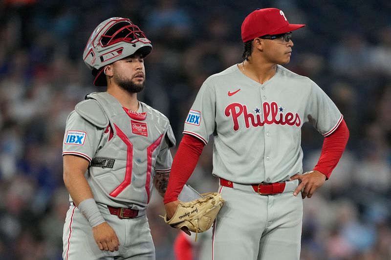 Jun 5, 2025; Toronto, Ontario, CAN; Philadelphia Phillies catcher Rafael Marchan (13) and starting pitcher Jesus Luzardo (44) look towards the bullpen after giving up four runs in the third inning against the Toronto Blue Jays at Rogers Centre. Mandatory Credit: John E. Sokolowski-Imagn Images