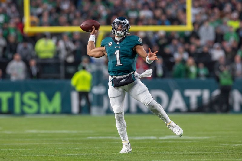 Philadelphia Eagles quarterback Jalen Hurts (1) rolls out and passes against the San Francisco 49ers in an NFL football game, Sunday, Dec. 3, 2023, in Philadelphia, PA. 49ers defeat the Eagles 42-19. (AP Photo/Jeff Lewis)