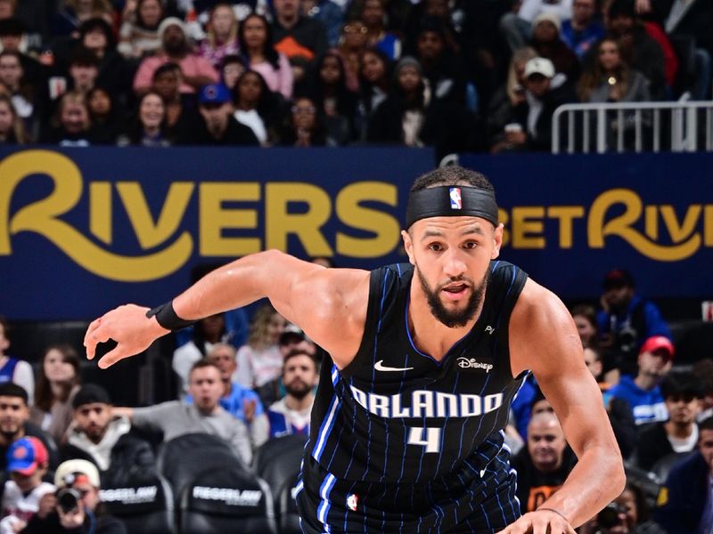 DETROIT, MI - JANUARY 1: Jalen Suggs #4 of the Orlando Magic dribbles the ball during the game against the Detroit Pistons on January 1, 2025 at Little Caesars Arena in Detroit, Michigan. NOTE TO USER: User expressly acknowledges and agrees that, by downloading and/or using this photograph, User is consenting to the terms and conditions of the Getty Images License Agreement. Mandatory Copyright Notice: Copyright 2025 NBAE (Photo by Chris Schwegler/NBAE via Getty Images)