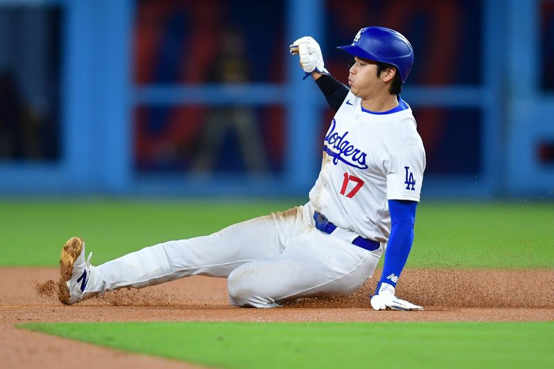 Apr 13, 2024; Los Angeles, California, USA; Los Angeles Dodgers designated hitter Shohei Ohtani (17) steals second against the San Diego Padres during the first inning at Dodger Stadium. Mandatory Credit: Gary A. Vasquez-USA TODAY Sports