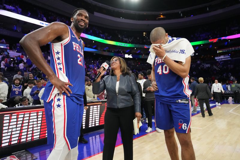 PHILADELPHIA, PA - APRIL 17: Joel Embiid #21 and Nicolas Batum #40 of the Philadelphia 76ers talks to the media after the game against the Miami Heat during the 2024 NBA Play-In Tournament on April 17, 2024 at the Wells Fargo Center in Philadelphia, Pennsylvania NOTE TO USER: User expressly acknowledges and agrees that, by downloading and/or using this Photograph, user is consenting to the terms and conditions of the Getty Images License Agreement. Mandatory Copyright Notice: Copyright 2024 NBAE (Photo by Jesse D. Garrabrant/NBAE via Getty Images)