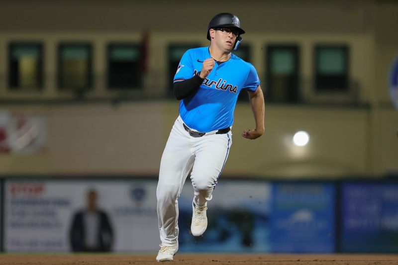 Mar 4, 2024; Jupiter, Florida, USA; Miami Marlins third baseman Jonah Bride (41) runs toward home plate after an RBI double by first baseman Josh Bell (not pictured) during the sixth inning at Roger Dean Chevrolet Stadium. Mandatory Credit: Sam Navarro-USA TODAY Sports