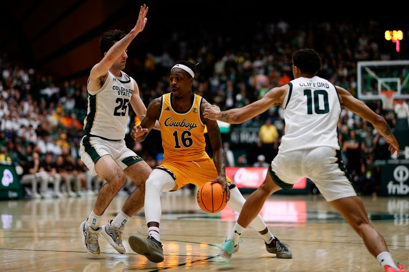 Feb 15, 2025; Fort Collins, Colorado, USA; Wyoming Cowboys guard Jordan Nesbitt (16) controls the ball under pressure from Colorado State Rams guard Ethan Morton (25) and guard Nique Clifford (10) in the first half at Moby Arena. Mandatory Credit: Isaiah J. Downing-Imagn Images