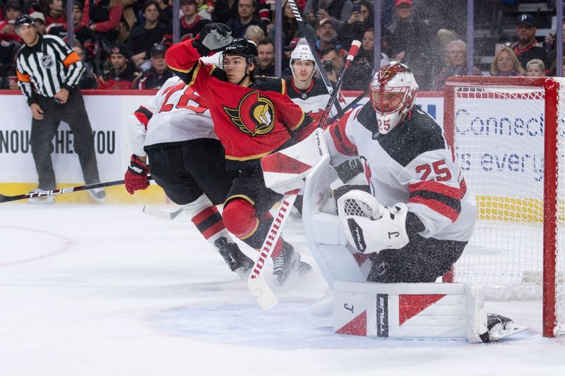 Dec 9, 2025; Ottawa, Ontario, CAN; Ottawa Senators defenseman Jordan Spence (10) and New Jersey Devils goalie Jacob Markstrom (25) follow the puck in the first period at the Canadian Tire Centre. Mandatory Credit: Marc DesRosiers-IMAGN Images