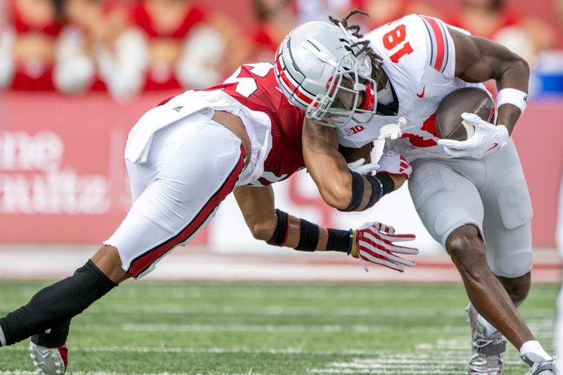 Sep 2, 2023; Bloomington, Indiana, USA; Ohio State Buckeyes wide receiver Marvin Harrison Jr. (18) is tackled by Indiana Hoosiers defensive back Nic Toomer (15) during the first quarter at Memorial Stadium. Mandatory Credit: Marc Lebryk-USA TODAY Sports