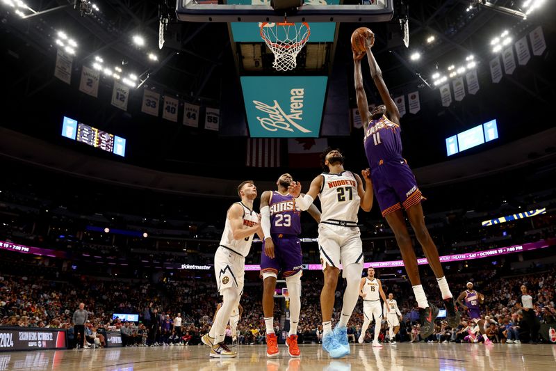 DENVER, COLORADO - OCTOBER 13: Bol Bol #11 of the Phoenix Suns dunks against the Denver Nuggets in the first half at Ball Arena on October 13, 2024 in Denver, Colorado. NOTE TO USER: User expressly acknowledges and agrees that, by downloading and/or using this Photograph, user is consenting to the terms and conditions of the Getty Images License Agreement. (Photo by Jamie Schwaberow/Getty Images)