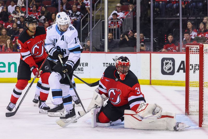 Oct 14, 2024; Newark, New Jersey, USA; New Jersey Devils goaltender Jake Allen (34) makes a save against the Utah Hockey Club during the third period at Prudential Center. Mandatory Credit: Ed Mulholland-Imagn Images