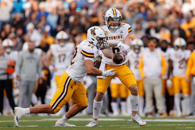 Oct 14, 2023; Colorado Springs, Colorado, USA; Wyoming Cowboys quarterback Andrew Peasley (6) hands the ball off to running back Sam Scott (22) in the first quarter against the Air Force Falcons at Falcon Stadium. Mandatory Credit: Isaiah J. Downing-USA TODAY Sports