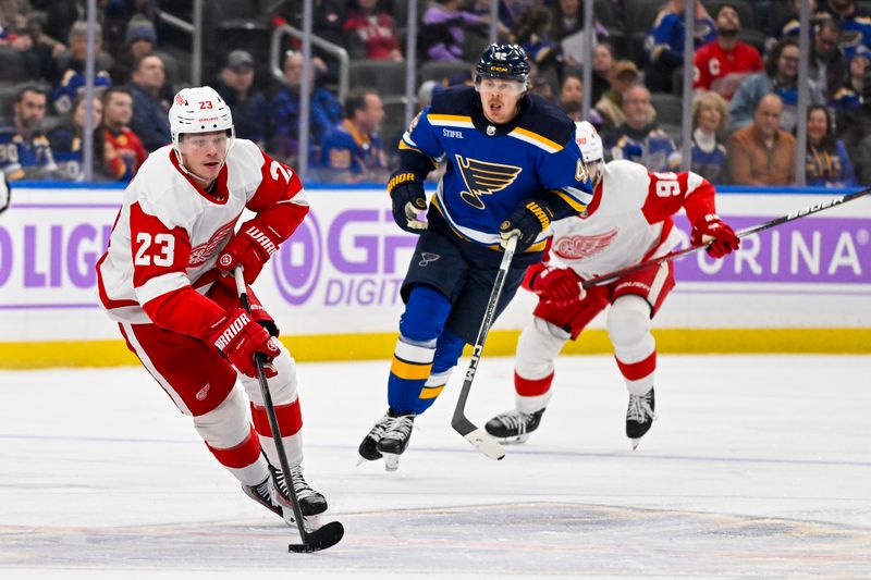 Dec 12, 2023; St. Louis, Missouri, USA;  Detroit Red Wings left wing Lucas Raymond (23) controls the puck against the St. Louis Blues during the first period at Enterprise Center. Mandatory Credit: Jeff Curry-USA TODAY Sports