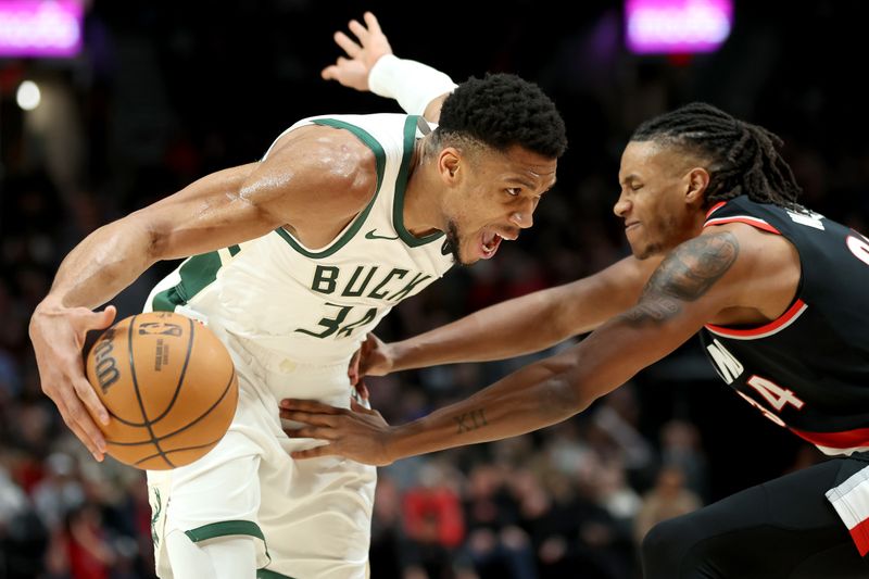 PORTLAND, OREGON - JANUARY 31: Giannis Antetokounmpo #34 of the Milwaukee Bucks dribbles against Jabari Walker #34 of the Portland Trail Blazers during the second quarter at Moda Center on January 31, 2024 in Portland, Oregon. (Photo by Steph Chambers/Getty Images)