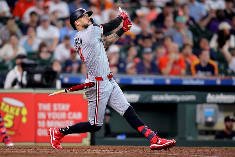 Jun 1, 2024; Houston, Texas, USA; Minnesota Twins shortstop Carlos Correa (4) hits an RBI single while breaking his bat against the Houston Astros during the eighth inning at Minute Maid Park. Mandatory Credit: Erik Williams-USA TODAY Sports