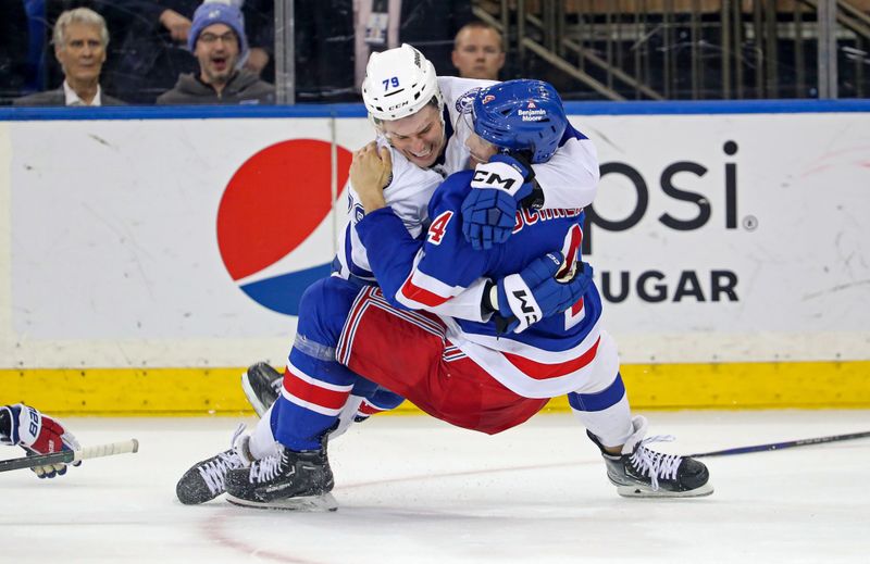 Apr 5, 2023; New York, New York, USA; Tampa Bay Lightning center Ross Colton (79) fights New York Rangers defenseman Braden Schneider (4) during the second period at Madison Square Garden. Mandatory Credit: Danny Wild-USA TODAY Sports