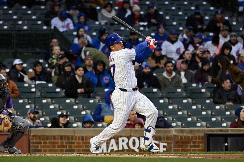 Apr 2, 2024; Chicago, Illinois, USA; Chicago Cubs right fielder Seiya Suzuki (27) hits a two-run home run against the Colorado Rockies during the first inning at Wrigley Field. Mandatory Credit: Matt Marton-USA TODAY Sports