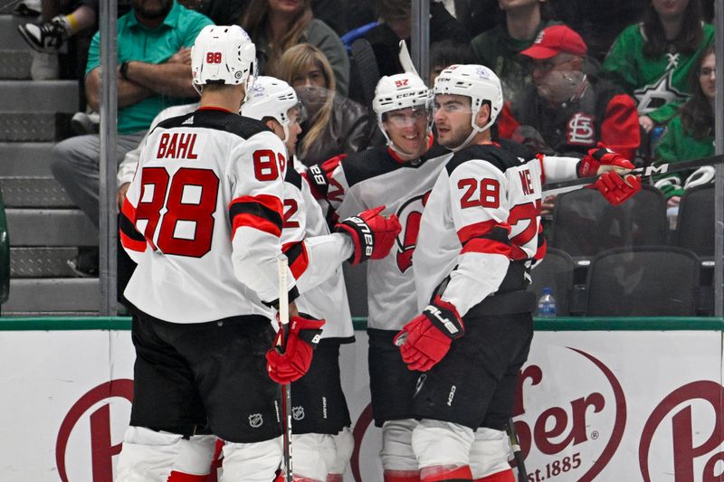 Mar 14, 2024; Dallas, Texas, USA; New Jersey Devils defenseman Kevin Bahl (88) and center Curtis Lazar (42) and right wing Timo Meier (28) celebrates a goal scored by Meier against the Dallas Stars during the second period at the American Airlines Center. Mandatory Credit: Jerome Miron-USA TODAY Sports