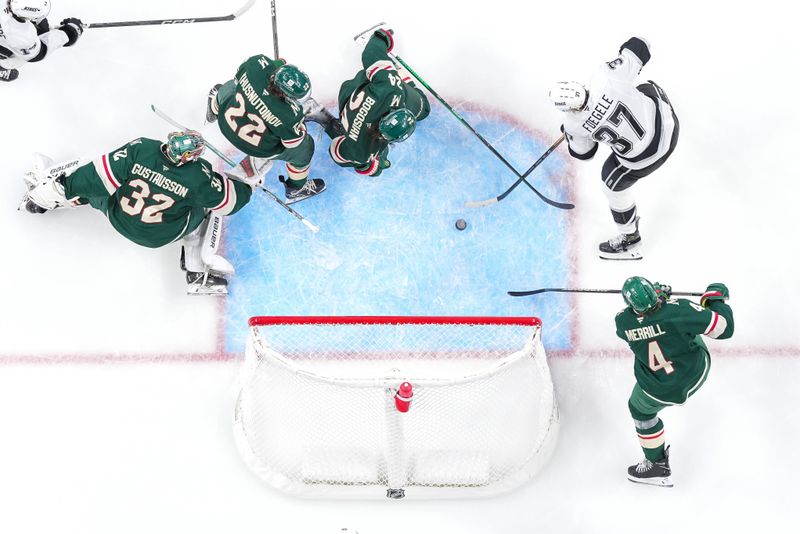 Nov 5, 2024; Saint Paul, Minnesota, USA; Los Angeles Kings left wing Warren Foegele (37) scores against the Minnesota Wild goaltender Filip Gustavsson (32) in the second period at Xcel Energy Center. Mandatory Credit: Brad Rempel-Imagn Images