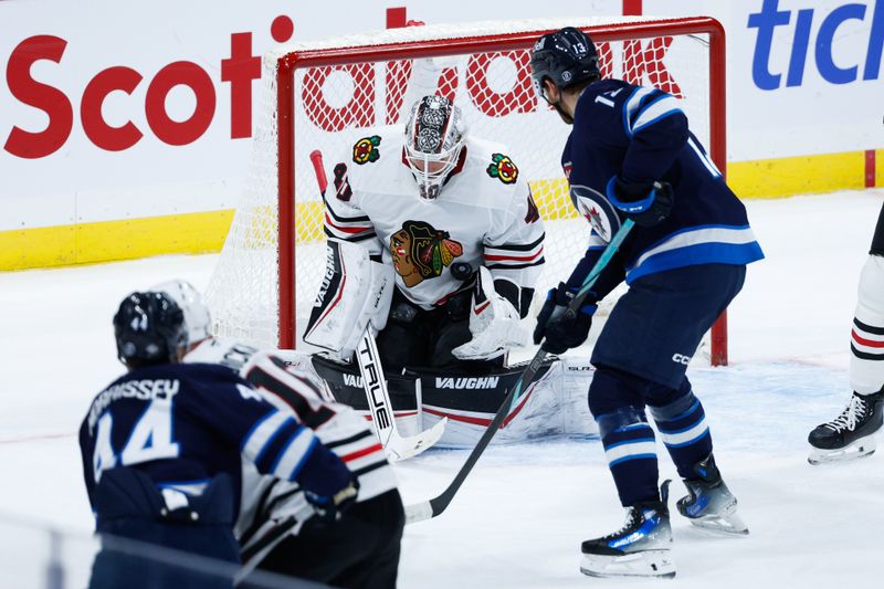 Oct 11, 2024; Winnipeg, Manitoba, CAN; Chicago Blackhawks goalie Arvid Soderblom (40) makes a save as Winnipeg Jets forward Gabriel Vilardi (13) looks for a rebound during the third period at Canada Life Centre. Mandatory Credit: Terrence Lee-Imagn Images