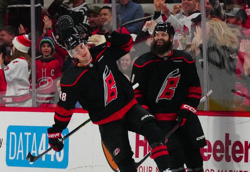 Jan 19, 2024; Raleigh, North Carolina, USA;  Carolina Hurricanes center Martin Necas (88) celebrates his goal against the Detroit Red Wings during the second period at PNC Arena. Mandatory Credit: James Guillory-USA TODAY Sports