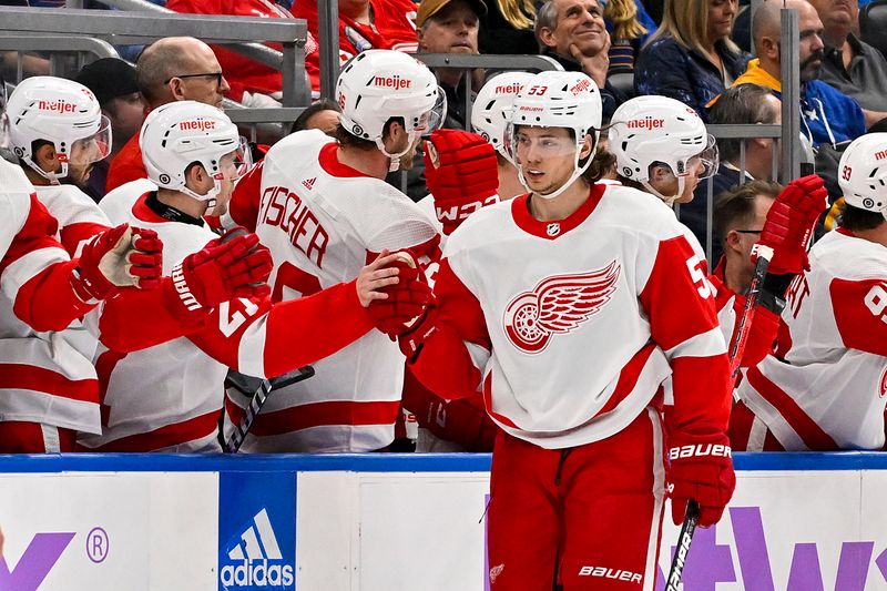 Dec 12, 2023; St. Louis, Missouri, USA;  Detroit Red Wings defenseman Moritz Seider (53) is congratulated by teammates after scoring against the St. Louis Blues during the second period at Enterprise Center. Mandatory Credit: Jeff Curry-USA TODAY Sports