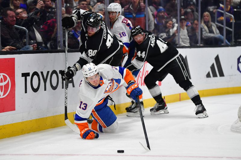 Mar 11, 2024; Los Angeles, California, USA; New York Islanders center Mathew Barzal (13) is tripped by Los Angeles Kings center Pierre-Luc Dubois (80) while playing for the puck during the third period at Crypto.com Arena. Mandatory Credit: Gary A. Vasquez-USA TODAY Sports