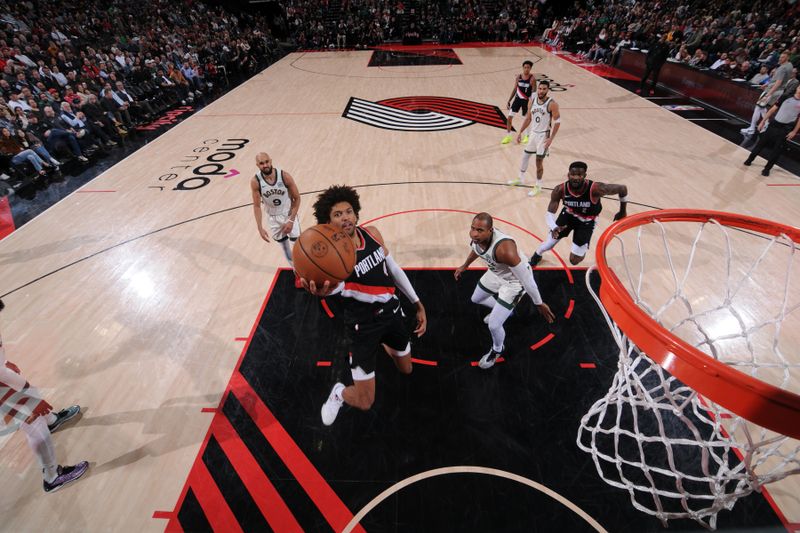 PORTLAND, OR - MARCH 11: Matisse Thybulle #4 of the Portland Trail Blazers drives to the basket during the game against the Boston Celtics on March 11, 2024 at the Moda Center Arena in Portland, Oregon. NOTE TO USER: User expressly acknowledges and agrees that, by downloading and or using this photograph, user is consenting to the terms and conditions of the Getty Images License Agreement. Mandatory Copyright Notice: Copyright 2024 NBAE (Photo by Cameron Browne/NBAE via Getty Images)