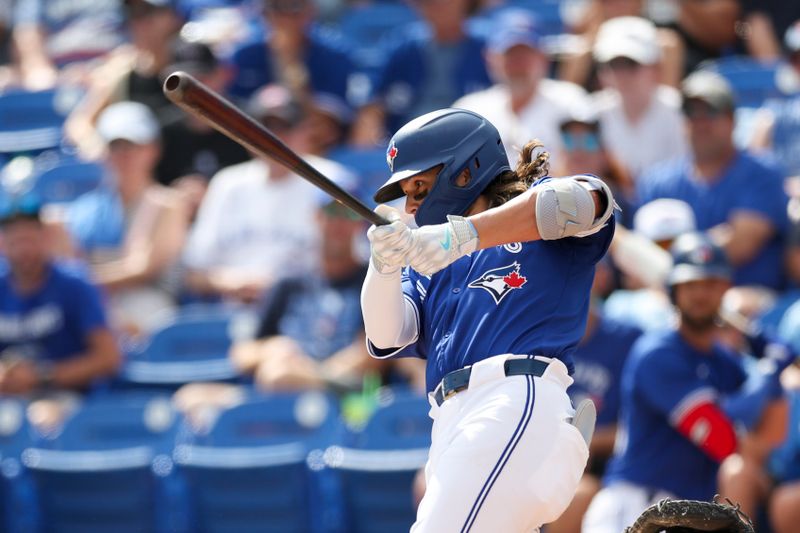 Mar 8, 2024; Dunedin, Florida, USA;  Toronto Blue Jays shortstop Bo Bichette (11) doubles against the New York Yankees in the sixth inning at TD Ballpark. Mandatory Credit: Nathan Ray Seebeck-USA TODAY Sports