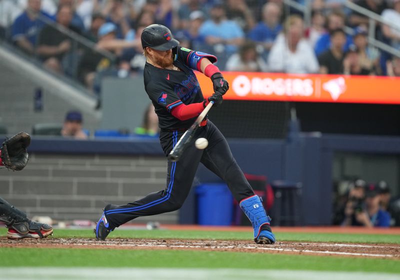 Jun 19, 2024; Toronto, Ontario, CAN; Toronto Blue Jays designated hitter Justin Turner (2) hits into a double play but scores a run against the Boston Red Sox during fourth inning at Rogers Centre. Mandatory Credit: Nick Turchiaro-USA TODAY Sports