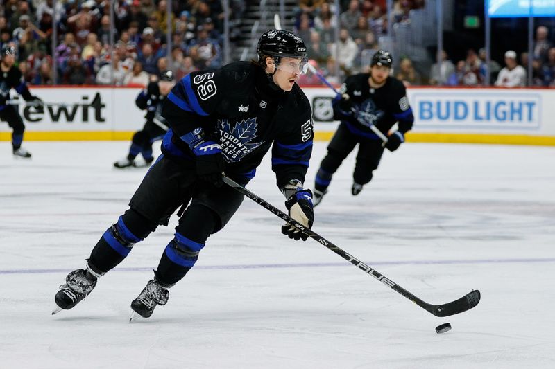 Feb 24, 2024; Denver, Colorado, USA; Toronto Maple Leafs left wing Tyler Bertuzzi (59) controls the puck in the first period against the Colorado Avalanche at Ball Arena. Mandatory Credit: Isaiah J. Downing-USA TODAY Sports