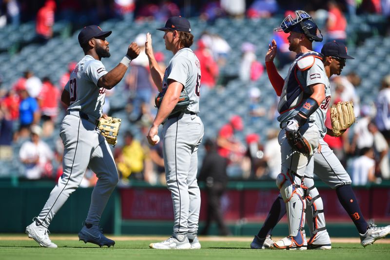 Jun 27, 2024; Anaheim, California, USA; Detroit Tigers left fielder Akil Baddoo (60) pitcher Tyler Holton (87) and catcher Carson Kelly (15) celebrate the victory against the Los Angeles Angels at Angel Stadium. Mandatory Credit: Gary A. Vasquez-USA TODAY Sports