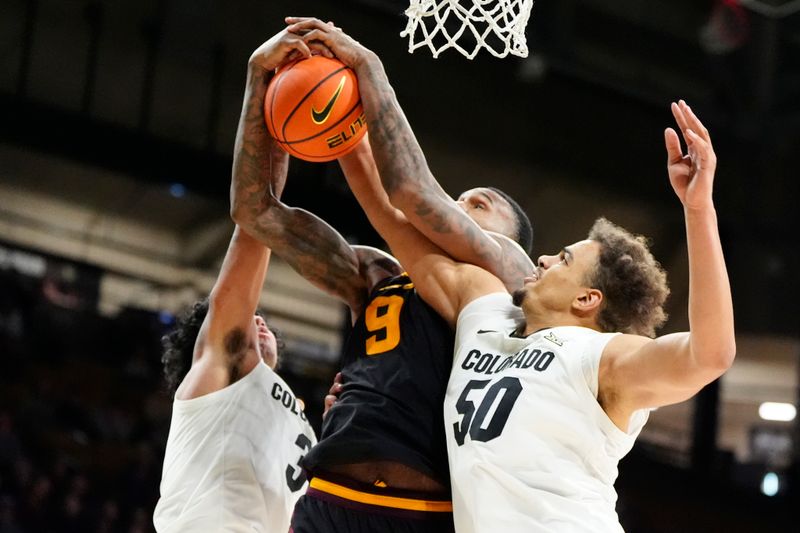 Jan 28, 2025; Boulder, Colorado, USA; Colorado Buffaloes center Elijah Malone (50) and guard Julian Hammond III (3) defend against Arizona State Sun Devils center Shawn Phillips Jr. (9) in the second half at CU Events Center. Mandatory Credit: Ron Chenoy-Imagn Images