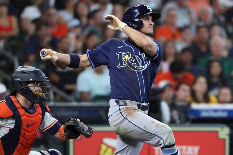May 31, 2025; Houston, Texas, USA; Tampa Bay Rays center fielder Jake Mangum (28) hits a home run during the seventh inning against the Houston Astros at Daikin Park. Mandatory Credit: Troy Taormina-Imagn Images