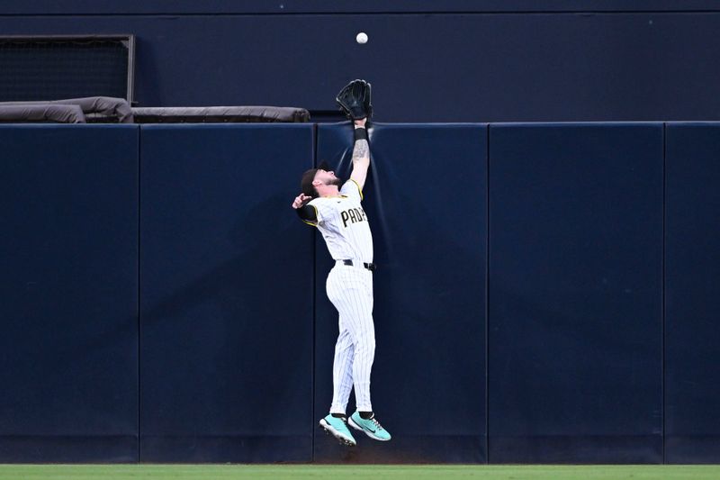 May 14, 2025; San Diego, California, USA; San Diego Padres center fielder Jackson Merrill (3) can’t make the catch on a solo home run hit by Los Angeles Angels left fielder Taylor Ward (3) during the second inning at Petco Park. Mandatory Credit: Denis Poroy-Imagn Images