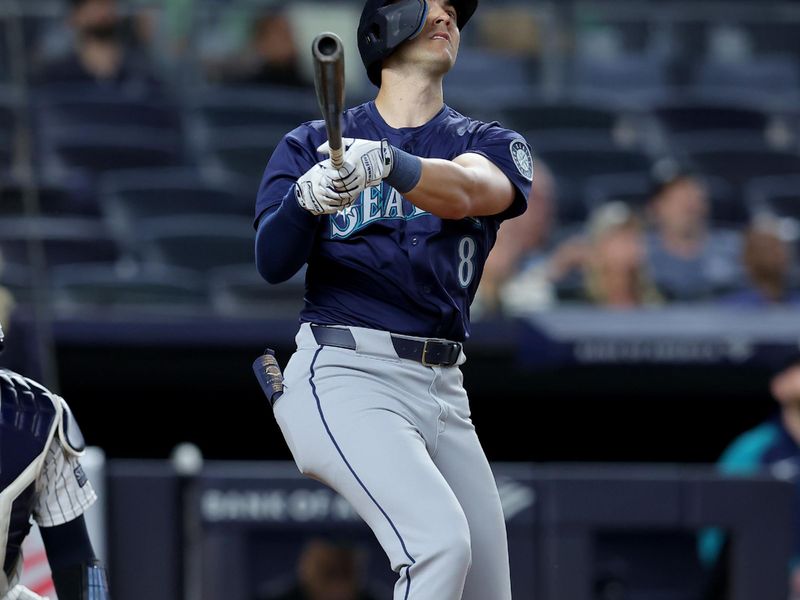 May 20, 2024; Bronx, New York, USA; Seattle Mariners right fielder Dominic Canzone (8) follows through on a game tying RBI sacrifice fly during the ninth inning against the New York Yankees at Yankee Stadium. Mandatory Credit: Brad Penner-USA TODAY Sports